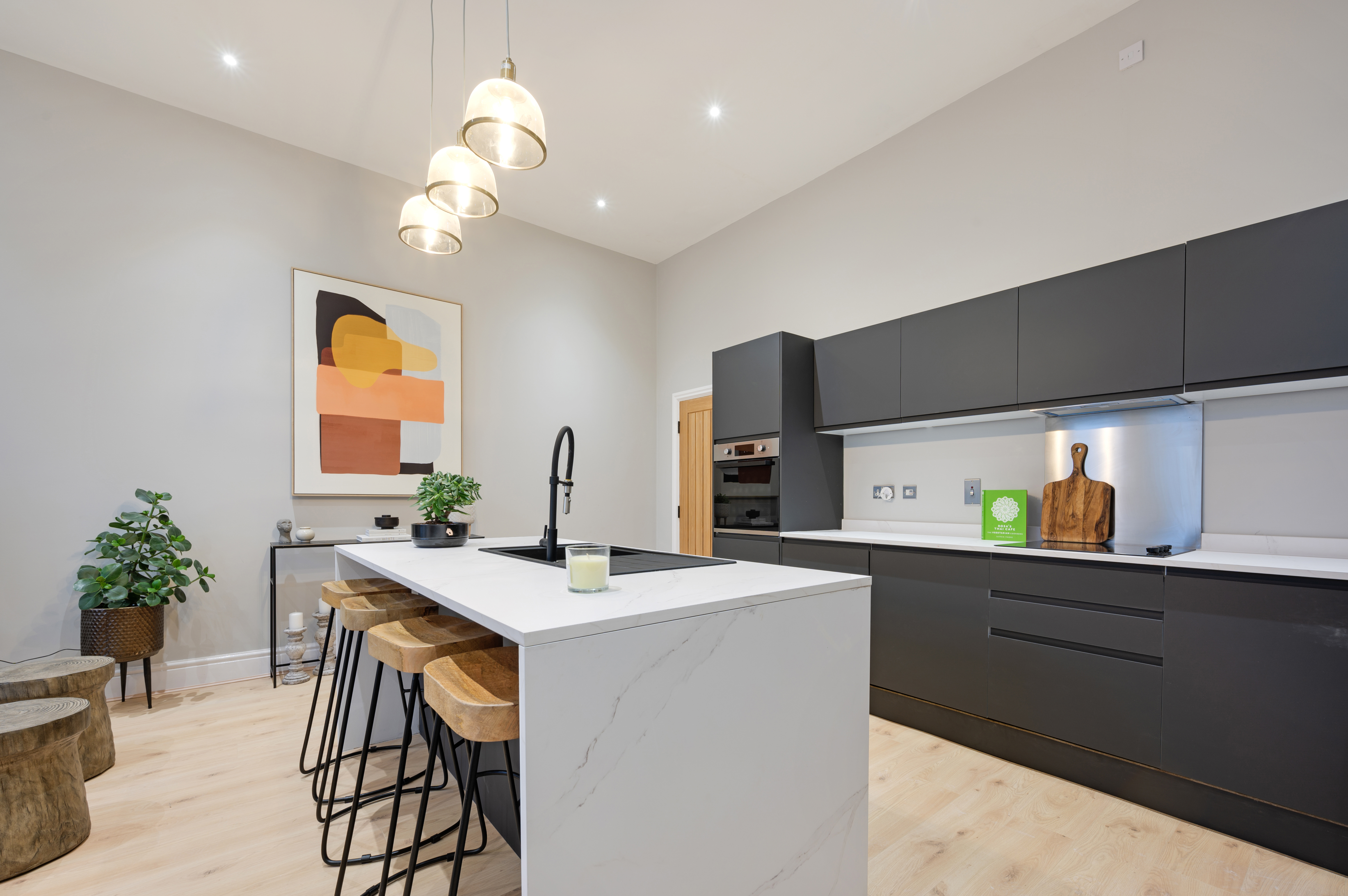 Aethos Homes — kitchen with statement artwork